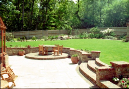The completed terrace, with low walls to enable larger groupings , for entertaining. The gently curved wall naturally leads the eye around the establishing garden
